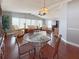 Open-concept dining area with large windows and hardwood floors at 112 Saint Pierres Way, Apollo Beach, FL 33572