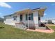 Charming home with a covered porch, quaint flower garden, and well-maintained lawn at 112 Saint Pierres Way, Apollo Beach, FL 33572