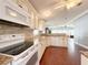 Modern kitchen with granite countertops, white appliances, and ample cabinet space at 112 Saint Pierres Way, Apollo Beach, FL 33572