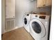 The laundry room boasts a new washer and dryer, with tile flooring, and a utility sink at 112 Saint Pierres Way, Apollo Beach, FL 33572