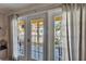 View from a balcony through french doors and sheer curtains at 17960 Gulf Blvd # 103, Redington Shores, FL 33708