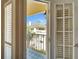 Balcony view showcasing the surrounding buildings and lush palm trees at 17960 Gulf Blvd # 103, Redington Shores, FL 33708