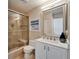 Bright bathroom featuring a glass shower, white vanity, and neutral color scheme at 17960 Gulf Blvd # 103, Redington Shores, FL 33708