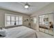 Bedroom with a large window, a ceiling fan, mirrored closet doors, and neutral decor at 17960 Gulf Blvd # 103, Redington Shores, FL 33708
