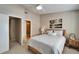 Bedroom features a ceiling fan, a window with shutters, and ensuite bathroom access at 17960 Gulf Blvd # 103, Redington Shores, FL 33708