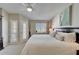Comfortable bedroom with white bedding, ceiling fan, and access to outdoor space at 17960 Gulf Blvd # 103, Redington Shores, FL 33708
