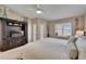 Comfortable bedroom with white bedding, ceiling fan, and entertainment center at 17960 Gulf Blvd # 103, Redington Shores, FL 33708