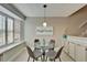 Bright dining area with bay window, modern table and chairs, and stylish decor at 17960 Gulf Blvd # 103, Redington Shores, FL 33708