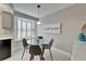 Bright dining area with bay window, modern table and chairs, and stylish decor at 17960 Gulf Blvd # 103, Redington Shores, FL 33708