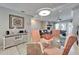 Dining room showcasing a glass table, stylish chairs, and a sideboard at 17960 Gulf Blvd # 103, Redington Shores, FL 33708