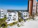 Beautiful beachfront condos with white exteriors, balconies, and palm trees offering stunning ocean views at 17960 Gulf Blvd # 103, Redington Shores, FL 33708