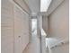 Bright hallway with multiple closet spaces leads to a bedroom with a window at 17960 Gulf Blvd # 103, Redington Shores, FL 33708