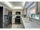 Modern kitchen with stainless steel appliances, light countertops, and neutral cabinetry at 17960 Gulf Blvd # 103, Redington Shores, FL 33708