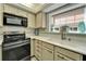 Modern kitchen with stainless steel appliances, light countertops, and neutral cabinetry at 17960 Gulf Blvd # 103, Redington Shores, FL 33708