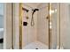 Shower room featuring tan tiles and a shower head with a glass partition at 17960 Gulf Blvd # 103, Redington Shores, FL 33708