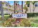 Community sign featuring Sunset Reef branding and manicured landscaping at 17960 Gulf Blvd # 103, Redington Shores, FL 33708