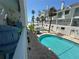 Inviting swimming pool surrounded by brick and palm trees in a tranquil community setting at 17960 Gulf Blvd # 103, Redington Shores, FL 33708