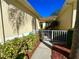 Charming courtyard entrance with a white gate and lush, well-maintained landscaping on a sunny day at 2116 Nantucket Dr # 19, Sun City Center, FL 33573