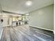 Spacious living room with new gray flooring and a seamless flow into the kitchen area at 2116 Nantucket Dr # 19, Sun City Center, FL 33573