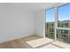 Bright bedroom with hardwood floors, white walls, and large windows that offer exterior views at 2702 N Woodrow Ave # 2, Tampa, FL 33602