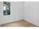 Clean, minimalist bedroom features hardwood floors and a bright window view at 2702 N Woodrow Ave # 2, Tampa, FL 33602