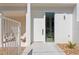 Modern entryway with a white door, side window, and a seating area at 2702 N Woodrow Ave # 2, Tampa, FL 33602