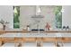 Kitchen island with seating and stainless steel appliances against a marble backsplash and view of greenery at 2702 N Woodrow Ave # 2, Tampa, FL 33602