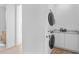 Convenient laundry room with modern stackable washer and dryer and white cabinets for storage at 2702 N Woodrow Ave # 2, Tampa, FL 33602