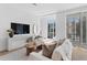 Modern living room with a sleek TV, neutral decor, and large windows overlooking the outdoors at 2702 N Woodrow Ave # 2, Tampa, FL 33602