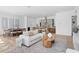 Open floor plan showcasing a modern living room and kitchen with wood floors and neutral tones at 2702 N Woodrow Ave # 2, Tampa, FL 33602