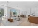 Bright living room with wood floors, neutral furniture, and an open layout connecting to the dining area at 2702 N Woodrow Ave # 2, Tampa, FL 33602