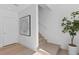 Bright interior view of stairs, modern art, light hardwood floors, and neutral tones at 2702 N Woodrow Ave # 2, Tampa, FL 33602
