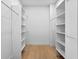Spacious walk-in closet featuring custom shelving, hanging rods, and sleek wood floors for optimal storage at 2702 N Woodrow Ave # 2, Tampa, FL 33602