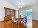 Dining room with a wooden table set and hardwood floors, with sliding doors leading to outdoor space at 2722 Scobee Dr, Palm Harbor, FL 34683