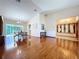 Bright and airy living space featuring wood floors, seamless transition to the entryway and dining area at 2722 Scobee Dr, Palm Harbor, FL 34683