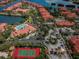 Beautiful aerial view of a resort-style community featuring pools, tennis courts, and manicured landscaping at 2757 Via Cipriani # 1114A, Clearwater, FL 33764