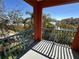 Charming balcony with ornate railings overlooking lush greenery and scenic waterfront views at 2757 Via Cipriani # 1114A, Clearwater, FL 33764
