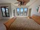 Spacious bedroom with large windows, ceiling fan, and tiled flooring at 2757 Via Cipriani # 1114A, Clearwater, FL 33764