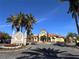Beautiful landscaped entrance to Grand Bellagio features lush tropical landscaping and elegant signage at 2757 Via Cipriani # 1114A, Clearwater, FL 33764