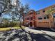 Inviting exterior showcasing a multi-level home with a two-car garage and lush landscaping at 2757 Via Cipriani # 1114A, Clearwater, FL 33764