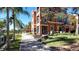 Beautifully maintained building with lush landscaping and a brick walkway at 2757 Via Cipriani # 1114A, Clearwater, FL 33764