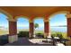 Charming gazebo view overlooking the water with comfortable seating and brick flooring at 2757 Via Cipriani # 1114A, Clearwater, FL 33764