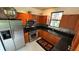 Updated kitchen featuring stainless steel appliances and dark granite countertops at 2757 Via Cipriani # 1114A, Clearwater, FL 33764