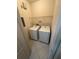 Convenient laundry room equipped with a washer, dryer, and shelving for storage at 2757 Via Cipriani # 1114A, Clearwater, FL 33764