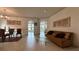Bright living room with tile floors, chandelier, furniture and ample natural light at 2757 Via Cipriani # 1114A, Clearwater, FL 33764