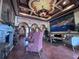 Spacious living room with high ceilings, a fireplace, elegant seating, and a mural for luxurious living at 2757 Via Cipriani # 1114A, Clearwater, FL 33764