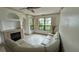 Comfortable living room with fireplace, tile floors, and windows with lake views at 2757 Via Cipriani # 1114A, Clearwater, FL 33764