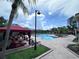 Inviting outdoor pool surrounded by lounge chairs, shaded cabanas, and tropical landscaping for relaxation at 2757 Via Cipriani # 1114A, Clearwater, FL 33764
