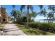 Picturesque sidewalk and landscaping with the bay view in the distance at 2757 Via Cipriani # 1114A, Clearwater, FL 33764