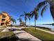 Beautiful waterfront view featuring a charming gazebo, walking paths, and tropical palm trees at 2757 Via Cipriani # 1114A, Clearwater, FL 33764